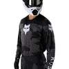 Fox Racing 180 BNKR Jersey in Black Camo, modeled front three-quarter view, with the crew neck, long sleeves, contrasting shoulder and arm graphics, and extended rear hem on a rider. Available options—Color: Black Camo; Size: XS, SM, MD, LG, XL, 2X. SKU 40649-247-M. UPC 198571123324.