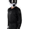 Fox Racing 180 Blackout Jersey in Black, modeled front three-quarter view, with the crew neck, long sleeves, contrasting shoulder and arm graphics, and extended rear hem on a rider. Available options—Color: Black; Size: XS, SM, MD, LG, XL, 2X, 3X. SKU 40650-001-M. UPC 198571122846.
