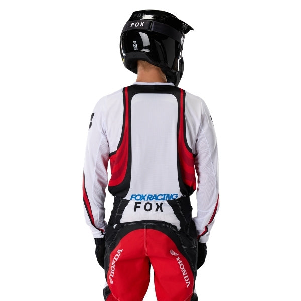Fox Racing 180 Honda Jersey in White/Red, close-up of the lower hem and drop-tail panel, with the printed Fox artwork, mesh-knit texture, reinforced seam lines, and shaped cuff or hem. Available options—Color: White/Red; Size: XS, SM, MD, LG, XL, 2X. SKU 40652-077-2X. UPC 198571132760.