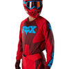 Fox Racing 180 Raid Jersey in Rust, modeled front three-quarter view, with the crew neck, long sleeves, contrasting shoulder and arm graphics, and extended rear hem on a rider. Available options—Color: Rust, Purple Lava, Deep Fern; Size: XS, SM, MD, LG, XL, 2X. SKU 40655-180-M. UPC 198571130858.
