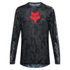 Fox Racing 180 Abyss Jersey in Black, front product view, with the crew neck, long sleeves, large Fox chest graphic, contrasting arm panels, and curved drop-tail hem. Available options—Color: Black; Size: XS, SM, MD, LG, XL, 2X. SKU 40656-001-XS. UPC 198571122266.