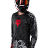 Fox Racing 180 Abyss Jersey in Black, modeled front three-quarter view, with the crew neck, long sleeves, contrasting shoulder and arm graphics, and extended rear hem on a rider. Available options—Color: Black; Size: XS, SM, MD, LG, XL, 2X. SKU 40656-001-M. UPC 198571122280.