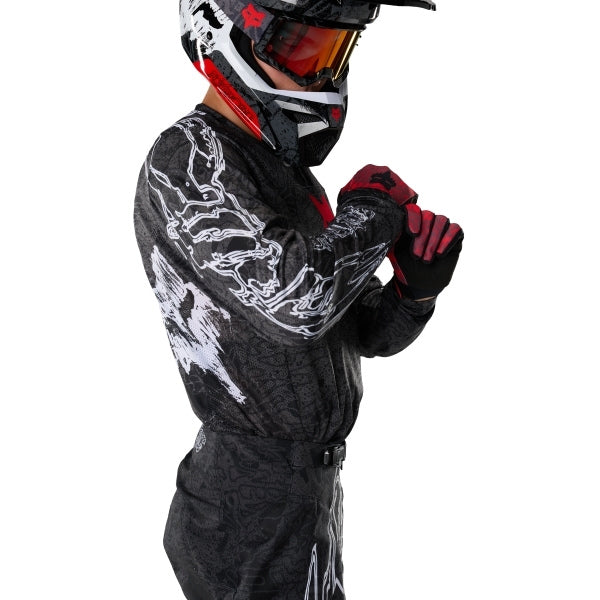 Fox Racing 180 Abyss Jersey in Black, close-up of the chest and shoulder panels, with the printed Fox artwork, mesh-knit texture, reinforced seam lines, and shaped cuff or hem. Available options—Color: Black; Size: XS, SM, MD, LG, XL, 2X. SKU 40656-001-L. UPC 198571122297.