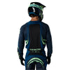 Fox Racing 180 Draft Jersey in Black, close-up of the lower hem and drop-tail panel, with the printed Fox artwork, mesh-knit texture, reinforced seam lines, and shaped cuff or hem. Available options—Color: White, Black, Sunburst; Size: XS, SM, MD, LG, XL, 2X. SKU 40657-001-2X. UPC 198571122709.