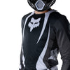Fox Racing Flexair Thorn Jersey in Black/White, modeled front three-quarter view, with the crew neck, long sleeves, contrasting shoulder and arm graphics, and extended rear hem on a rider. Available options—Color: Black/White, Purple Lava, Red; Size: SM, MD, LG, XL, 2X. SKU 40658-018-L. UPC 198571123744.