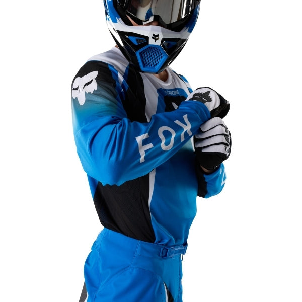 Fox Racing 180 Frame Jersey in Blue, close-up of the chest and shoulder panels, with the printed Fox artwork, mesh-knit texture, reinforced seam lines, and shaped cuff or hem. Available options—Color: Blue, Grey/Yellow, Black, Red; Size: XS, SM, MD, LG, XL, 2X, 3X. SKU 40665-002-L. UPC 198571124024.