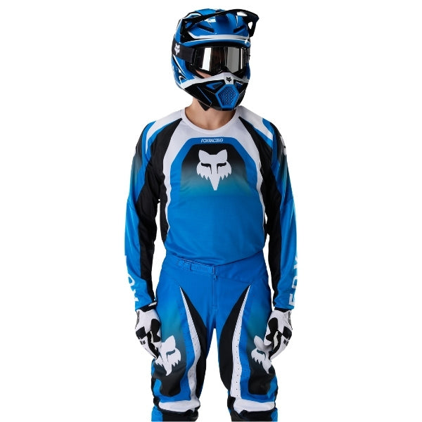 Fox Racing 180 Frame Jersey in Blue, close-up of the sleeve graphic and cuff, with the printed Fox artwork, mesh-knit texture, reinforced seam lines, and shaped cuff or hem. Available options—Color: Blue, Grey/Yellow, Black, Red; Size: XS, SM, MD, LG, XL, 2X, 3X. SKU 40665-002-XL. UPC 198571124031.