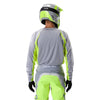Fox Racing 180 Frame Jersey in Grey/Yellow, close-up of the lower hem and drop-tail panel, with the printed Fox artwork, mesh-knit texture, reinforced seam lines, and shaped cuff or hem. Available options—Color: Blue, Grey/Yellow, Black, Red; Size: XS, SM, MD, LG, XL, 2X, 3X. SKU 40665-086-2X. UPC 198571126103.