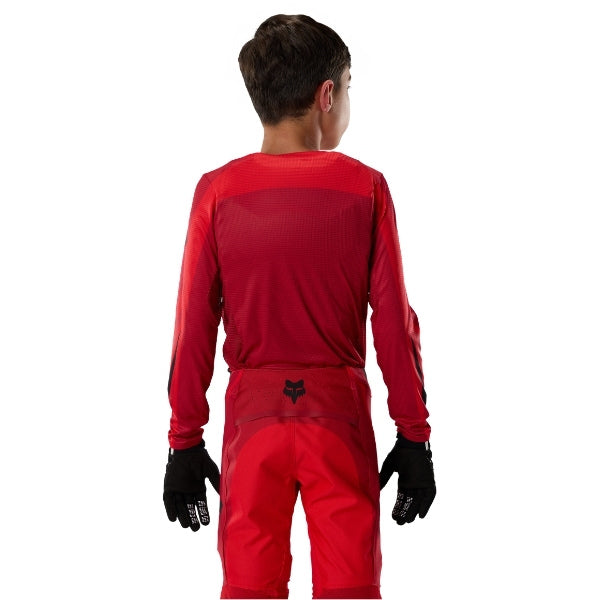 Fox Racing Flexair Arc Jersey (Youth) in Chili, full modeled rear view, with the back graphic, shoulder panels, long sleeves, and drop-tail hem. Available options—Color: Ice Blue, Chili; Size: Y-SM, Y-MD, Y-LG, Y-XL.