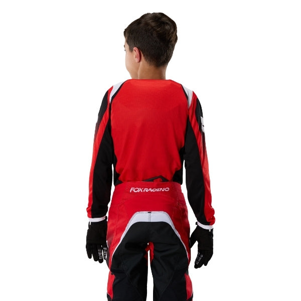 Fox Racing 180 Frame Jersey (Youth) in Red, full modeled rear view, with the back graphic, shoulder panels, long sleeves, and drop-tail hem. Available options—Color: Blue, Grey/Yellow, Black, Red; Size: Y-SM, Y-MD, Y-LG, Y-XL.