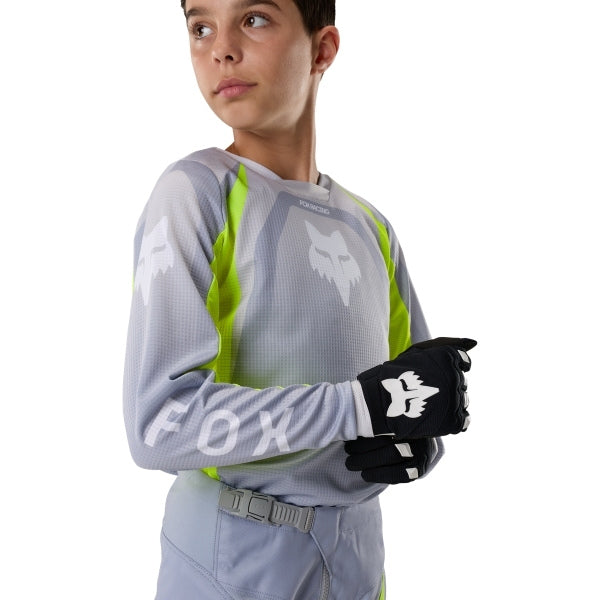 Fox Racing 180 Frame Jersey (Youth) in Grey/Yellow, close-up of the chest and shoulder panels, with the printed Fox artwork, mesh-knit texture, reinforced seam lines, and shaped cuff or hem. Available options—Color: Blue, Grey/Yellow, Black, Red; Size: Y-SM, Y-MD, Y-LG, Y-XL. SKU 40672-086-YXL. UPC 198571126141.