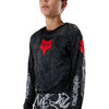 Fox Racing 180 Abyss Jersey (Youth) in Black, modeled front three-quarter view, with the crew neck, long sleeves, contrasting shoulder and arm graphics, and extended rear hem on a rider. Available options—Color: Black; Size: Y-SM, Y-MD, Y-LG, Y-XL. SKU 40680-001-YL. UPC 198571122556.