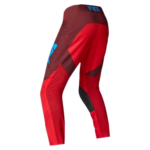 Fox Racing 180 Raid Pants in Rust, rear product view, with the reinforced seat, rear yoke, articulated knees, tapered legs, and lower-leg graphics. Available options—Color: Rust, Purple Lava, Deep Fern; Size: 28, 30, 32, 34, 36, 38. SKU 40685-180-30. UPC 198571130902.