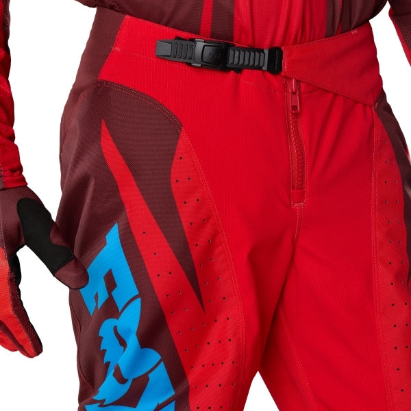 Fox Racing 180 Raid Pants in Rust, close-up of the waist and hip panels, with the ratcheting waist adjuster, stretch yoke, shaped hip panel, and reinforced knee or thigh material. Available options—Color: Rust, Purple Lava, Deep Fern; Size: 28, 30, 32, 34, 36, 38. SKU 40685-180-32. UPC 198571130919.