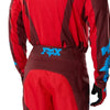 Fox Racing 180 Raid Pants in Rust, close-up of the ratcheting waist closure, with the ratcheting waist adjuster, stretch yoke, shaped hip panel, and reinforced knee or thigh material. Available options—Color: Rust, Purple Lava, Deep Fern; Size: 28, 30, 32, 34, 36, 38. SKU 40685-180-34. UPC 198571130926.