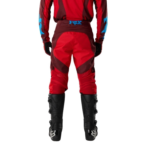 Fox Racing 180 Raid Pants in Rust, rear lower-leg and cuff view, with the reinforced seat, rear yoke, articulated knees, tapered legs, and lower-leg graphics. Available options—Color: Rust, Purple Lava, Deep Fern; Size: 28, 30, 32, 34, 36, 38. SKU 40685-180-38. UPC 198571130940.