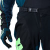 Fox Racing 180 Draft Pants in Black, close-up of the waist and hip panels, with the ratcheting waist adjuster, stretch yoke, shaped hip panel, and reinforced knee or thigh material. Available options—Color: White, Black, Sunburst; Size: 28, 30, 32, 34, 36, 38. SKU 40687-001-32. UPC 198571121887.