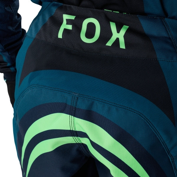 Fox Racing 180 Draft Pants in Black, close-up of the ratcheting waist closure, with the ratcheting waist adjuster, stretch yoke, shaped hip panel, and reinforced knee or thigh material. Available options—Color: White, Black, Sunburst; Size: 28, 30, 32, 34, 36, 38. SKU 40687-001-34. UPC 198571121894.