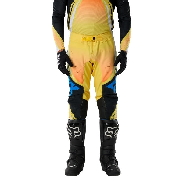 Fox Racing Flexair Arc Pants in Yellow, close-up of the side thigh and knee panels, with the ratcheting waist adjuster, stretch yoke, shaped hip panel, and reinforced knee or thigh material. Available options—Color: Yellow, Ice Blue, Chili; Size: 28, 30, 32, 34, 36, 38. SKU 40689-005-36. UPC 198571132937.