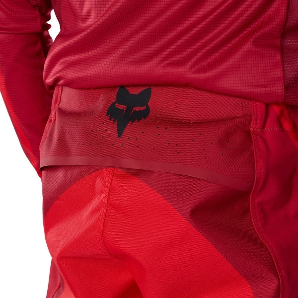 Fox Racing Flexair Arc Pants in Chili, close-up of the ratcheting waist closure, with the ratcheting waist adjuster, stretch yoke, shaped hip panel, and reinforced knee or thigh material. Available options—Color: Yellow, Ice Blue, Chili; Size: 28, 30, 32, 34, 36, 38. SKU 40689-555-34. UPC 198571124468.
