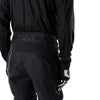 Fox Racing 180 Blackout Pants in Black, close-up of the ratcheting waist closure, with the ratcheting waist adjuster, stretch yoke, shaped hip panel, and reinforced knee or thigh material. Available options—Color: Black; Size: 26, 28, 30, 32, 34, 36, 38, 40, 42, 44. SKU 40693-001-32. UPC 198571121955.