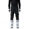 Fox Racing 180 Blackout Pants in Black, close-up of the side thigh and knee panels, with the ratcheting waist adjuster, stretch yoke, shaped hip panel, and reinforced knee or thigh material. Available options—Color: Black; Size: 26, 28, 30, 32, 34, 36, 38, 40, 42, 44. SKU 40693-001-34. UPC 198571121962.