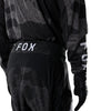 Fox Racing 180 BNKR Pants in Black Camo, close-up of the ratcheting waist closure, with the ratcheting waist adjuster, stretch yoke, shaped hip panel, and reinforced knee or thigh material. Available options—Color: Black Camo; Size: 26, 28, 30, 32, 34, 36, 38. SKU 40694-247-32. UPC 198571133675.