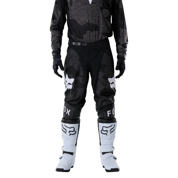Fox Racing 180 BNKR Pants in Black Camo, close-up of the side thigh and knee panels, with the ratcheting waist adjuster, stretch yoke, shaped hip panel, and reinforced knee or thigh material. Available options—Color: Black Camo; Size: 26, 28, 30, 32, 34, 36, 38. SKU 40694-247-34. UPC 198571133682.