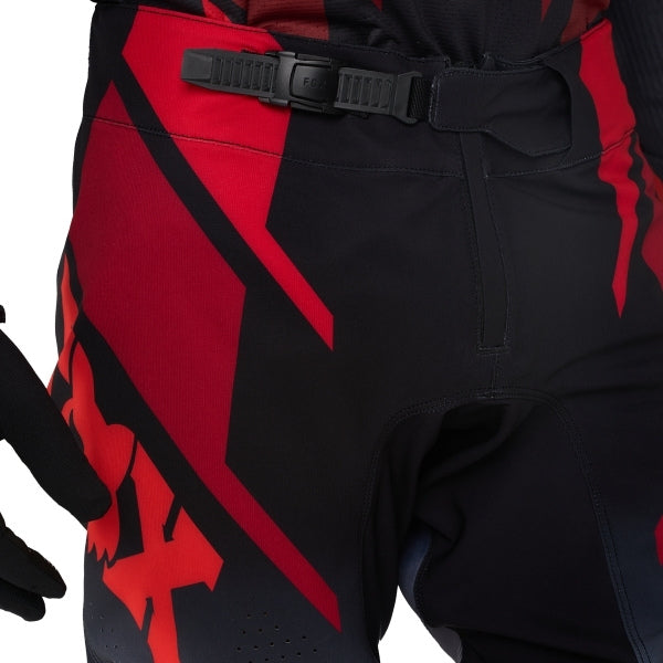 Fox Racing 360 Foundry Pants in Flo Red, close-up of the waist and hip panels, with the ratcheting waist adjuster, stretch yoke, shaped hip panel, and reinforced knee or thigh material. Available options—Color: Black/Grey, Flo Red, Sky Blue, HiViz Yellow; Size: 28, 30, 32, 34, 36, 38. SKU 40695-110-32. UPC 198571125533.