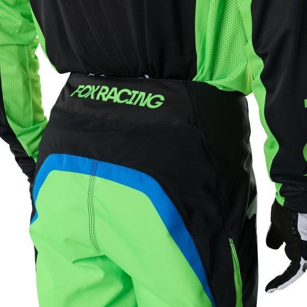 Fox Racing 180 Kawasaki Pants in Black, close-up of the ratcheting waist closure, with the ratcheting waist adjuster, stretch yoke, shaped hip panel, and reinforced knee or thigh material. Available options—Color: Black; Size: 26, 28, 30, 32, 34, 36, 38. SKU 40697-001-32. UPC 198571122051.