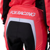 Fox Racing 180 Frame Pants (Womens) in Neon Pink, close-up of the ratcheting waist closure, with the ratcheting waist adjuster, stretch yoke, shaped hip panel, and reinforced knee or thigh material. Available options—Color: Neon Pink, Deep Blue; Size: 2, 4, 6, 8, 10, 12, 14, 16. SKU 40699-065-8. UPC 198571128176.