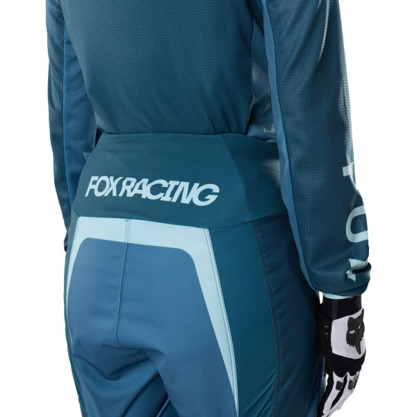 Fox Racing 180 Frame Pants (Womens) in Deep Blue, rear product view, with the reinforced seat, rear yoke, articulated knees, tapered legs, and lower-leg graphics. Available options—Color: Neon Pink, Deep Blue; Size: 2, 4, 6, 8, 10, 12, 14, 16. SKU 40699-E19-4. UPC 198571124857.
