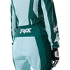 Fox Racing 180 Raid Pants (Womens) in Melon, rear product view, with the reinforced seat, rear yoke, articulated knees, tapered legs, and lower-leg graphics. Available options—Color: Lavender Drift, Melon; Size: 2, 4, 6, 8, 10, 12, 14, 16. SKU 40700-413-4. UPC 198571127537.