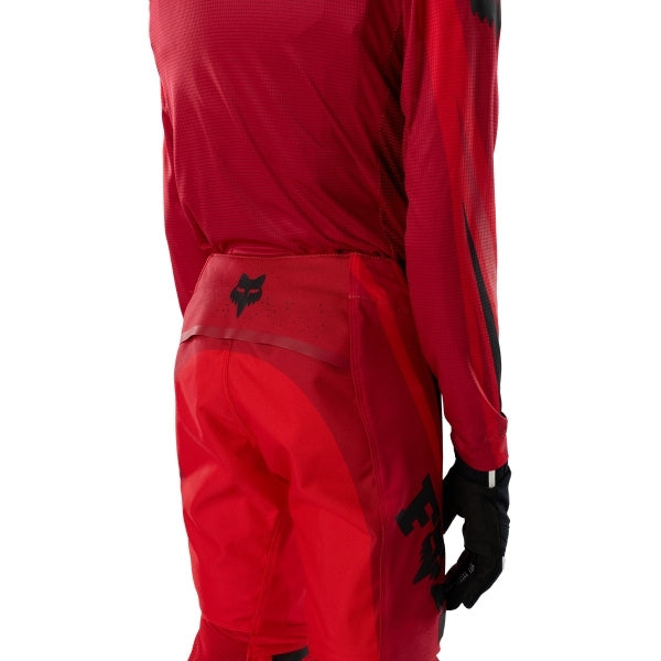 Fox Racing Flexair Arc Pants (Youth) in Chili, rear lower-leg and cuff view, with the reinforced seat, rear yoke, articulated knees, tapered legs, and lower-leg graphics. Available options—Color: Ice Blue, Chili; Size: Y-22, Y-24, Y-26, Y-28.
