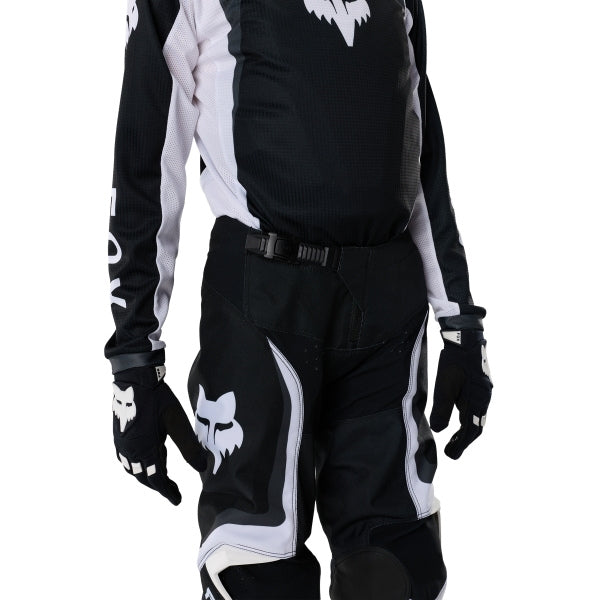 Fox Racing 180 Frame Pants (Youth) in Red, close-up of the waist and hip panels, with the ratcheting waist adjuster, stretch yoke, shaped hip panel, and reinforced knee or thigh material. Available options—Color: Blue, Grey/Yellow, Black, Red; Size: Y-22, Y-24, Y-26, Y-28. SKU 40702-003-26. UPC 198571130155.