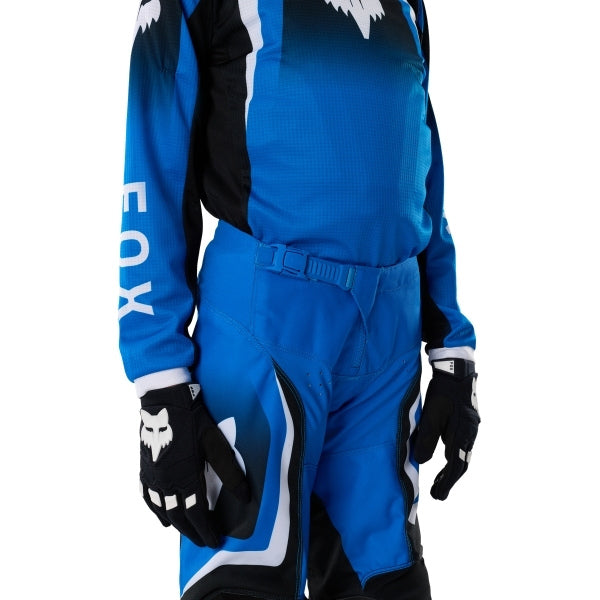 Fox Racing 180 Frame Pants (Youth) in Blue, close-up of the waist and hip panels, with the ratcheting waist adjuster, stretch yoke, shaped hip panel, and reinforced knee or thigh material. Available options—Color: Blue, Grey/Yellow, Black, Red; Size: Y-22, Y-24, Y-26, Y-28. SKU 40702-002-26. UPC 198571124130.