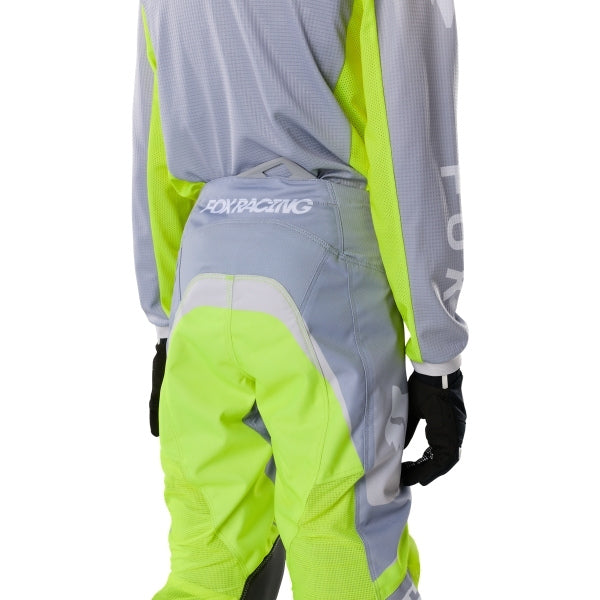 Fox Racing 180 Frame Pants (Youth) in Black, rear product view, with the reinforced seat, rear yoke, articulated knees, tapered legs, and lower-leg graphics. Available options—Color: Blue, Grey/Yellow, Black, Red; Size: Y-22, Y-24, Y-26, Y-28. SKU 40702-001-24. UPC 198571122792.