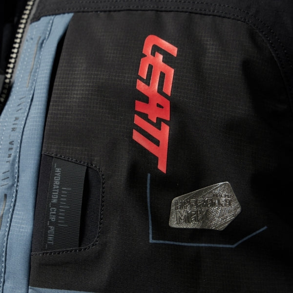 Leatt Moto 6.5 HydraDri Jacket in Grey, close-up of the upper chest zipper and feature labels