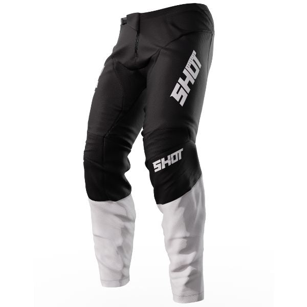 Left Side Shot Race Gear Reflex Pants black—ultra-light (≈450 g), 600D chassis, stretch panels, leather heat guards; vented liner. Sizes 28–42. SKU A08-11C1-A01-28.