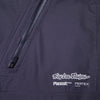 Troy Lee Designs Resist Pro Mono mountain bike overalls in Carbon, close-up of the zippered pocket and Troy Lee Designs Resist branding