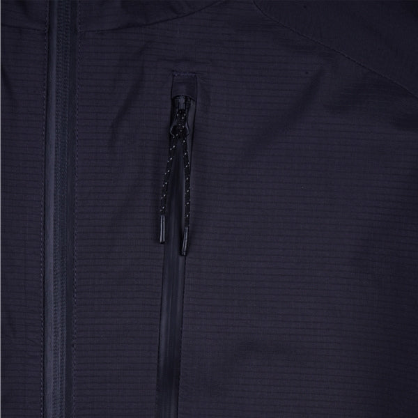 Troy Lee Designs Resist Pro Mono mountain bike jacket in Carbon, close-up highlighting a zipper, pocket construction, seams, and surrounding fabric