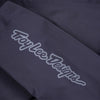 Troy Lee Designs Resist Pro Mono mountain bike jacket in Carbon, close-up highlighting the sleeve, side-panel construction, and Troy Lee Designs branding