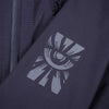 Troy Lee Designs Resist Pro Mono mountain bike jacket in Carbon, worn by a rider, showing the overall fit, front closure, and color-blocked panels