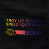 A close-up shot of the left sleeve of the Troy Lee Designs SE PRO JERSEY in black/multi, focusing on the cuff area. A small, black square patch with a white 