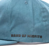 Fasthouse Spanner Hat SKU 3210050 – side panel close-up with “Band of Misfits” text in black, blue fabric construction.