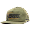 SKU 3210050 – Fasthouse Spanner Hat in olive green, front angle view showing “Fasthouse Cycles Worldwide” embroidered logo with flaming wrench graphic, flat bill design, popular with motocross and dirt bike riders.
