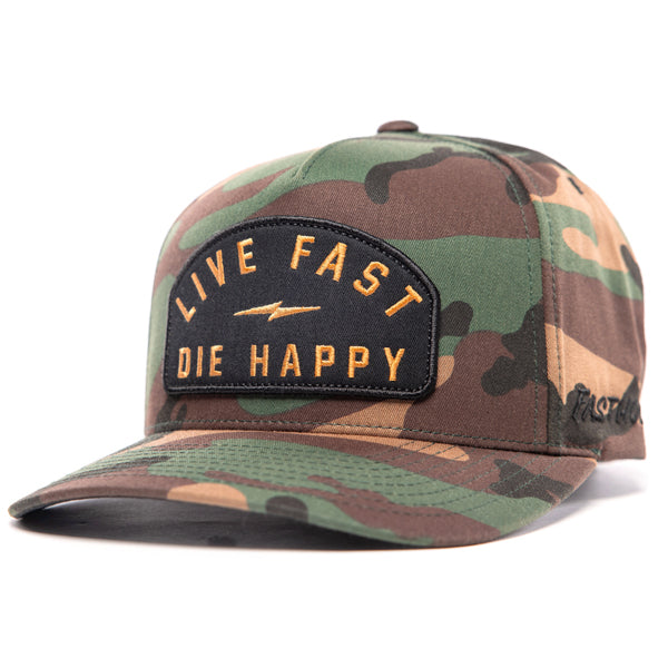 Fasthouse Wired Hat SKU 3321098 in woodland camouflage, structured snapback style with curved bill, featuring bold front patch that reads “Live Fast Die Happy,” designed for motocross riders and casual streetwear.